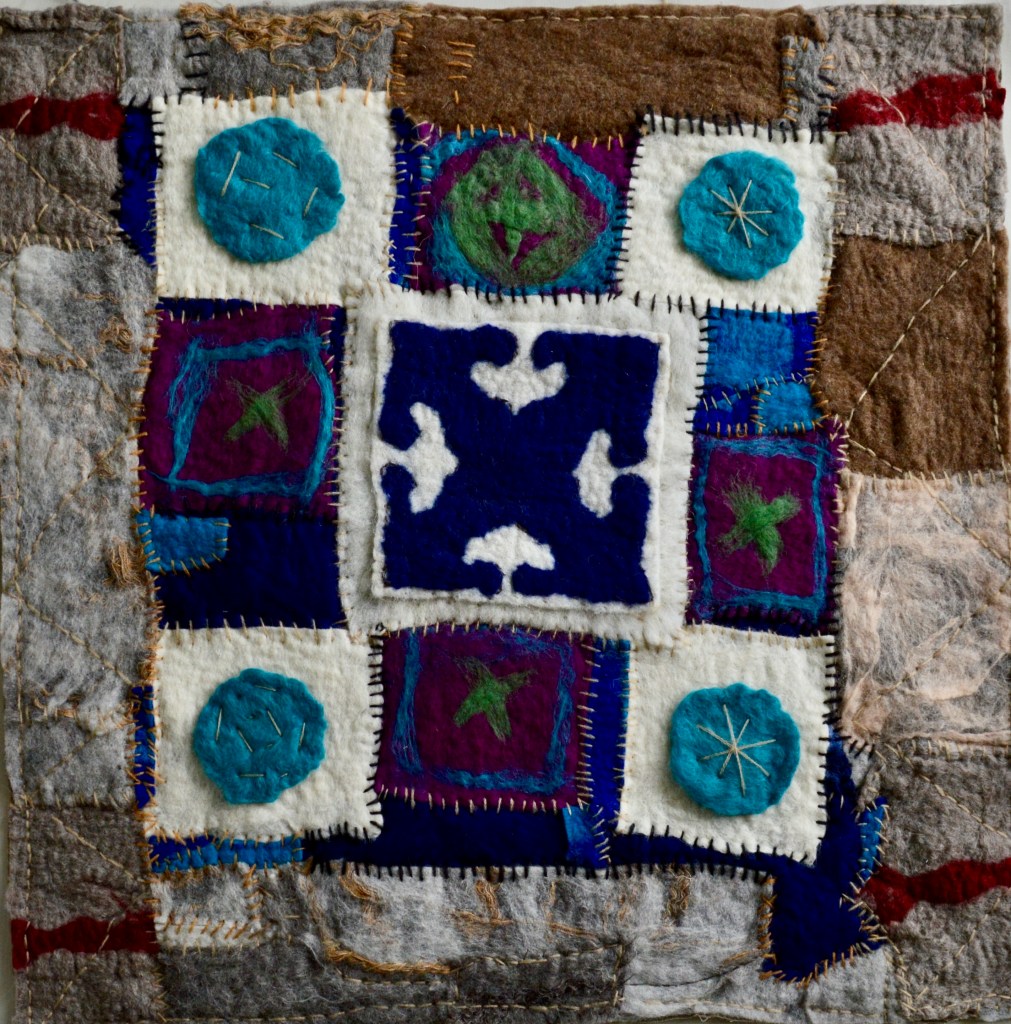 Geometric felt collage inspired by Persian garden design and nomadic architecture, featuring stitched squares in deep blue, white, and violet, with circular felt motifs and layered textures suggesting ornamental balance and modular construction.
