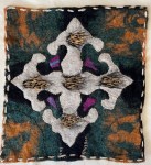 Felt composition with a large ornamental motif in soft grey and black, set against a marbled background of dark green and amber tones, inspired by Persian design elements and textile tradition.