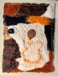 Felt collage combining warm rust, dark brown, and cream-colored wool patches with hand-stitching and a circular central element, suggesting warmth, protection, and ancestral layering.