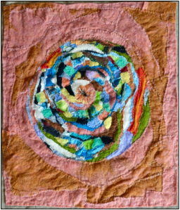 Felt collage with concentric circular patchwork in bright greens, blues, and earth tones, spiraling across a warm terracotta background — suggesting movement, memory, and cyclical growth.